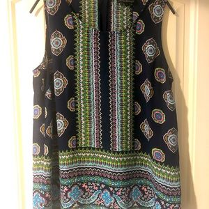 Sleeveless top, buttons down back.